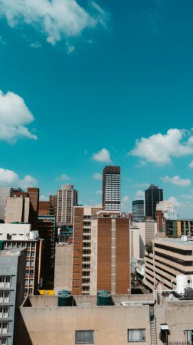 View of a city skyline against a blue sky.