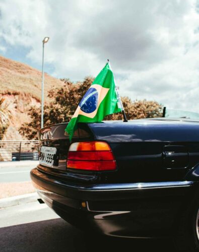 Brazil flag on tail of blue car