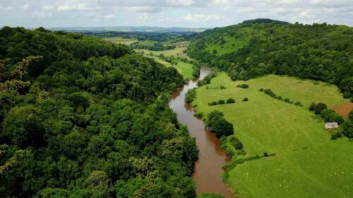 Photo of the Wye River Valley, with lush, green hills.
